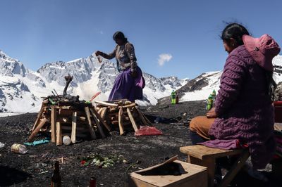 Bolivian artisan prepares traditional Pachamama offerings in El Alto