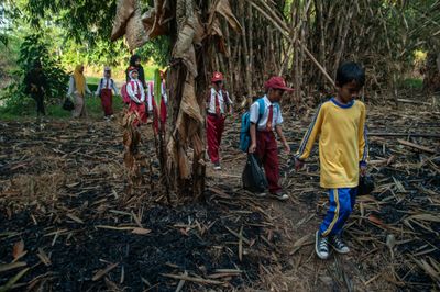 Elementary School Students Cross River to Reach School in Banten