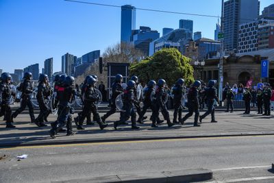 Right-wing groups join March for Australia rally in Melbourne