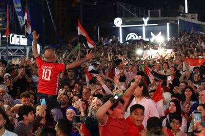 Palestinian fans cheer on the Egyptian national team in their round of 16 match at the FIFA World Cup.